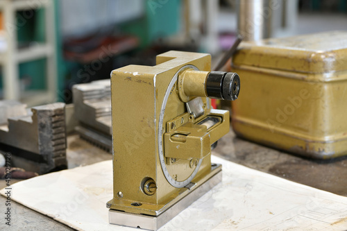 Optical quadrant in the production of tapered mandrels for metal working machines. Protractor tool for measuring the angle of inclination of planes to the horizontal. photo