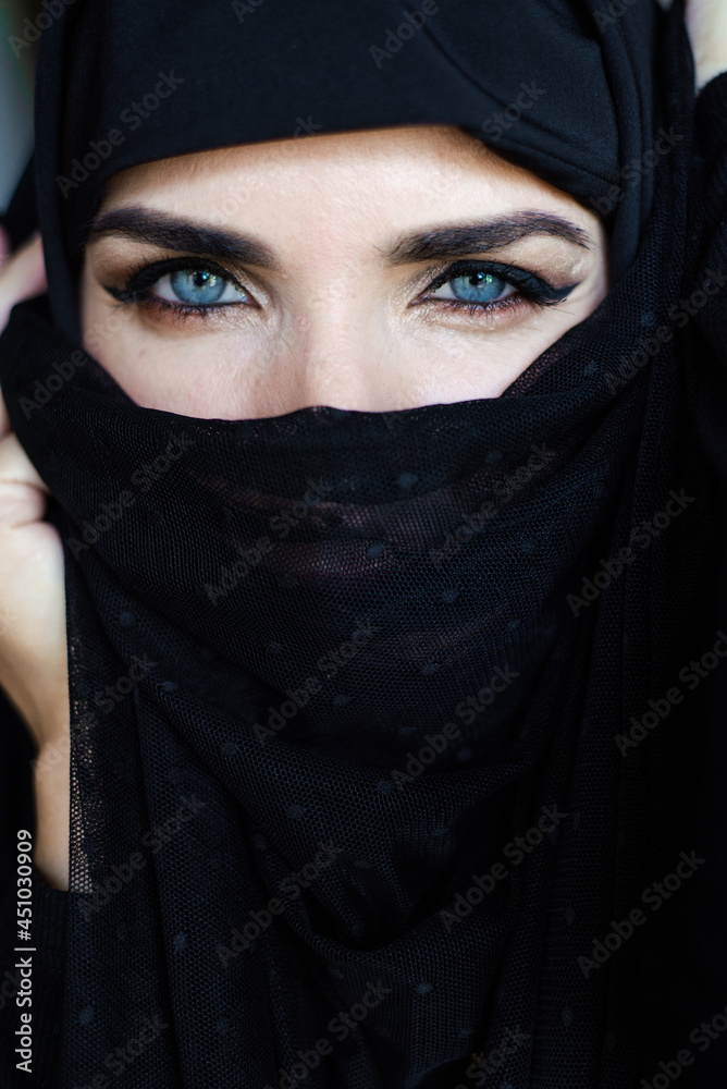 Young asian muslim woman in head scarf smile. Beautiful middle eastern woman wearing abaya. Arabian woman. Strict formal outfit and elegant appearance. Islamic fashion.