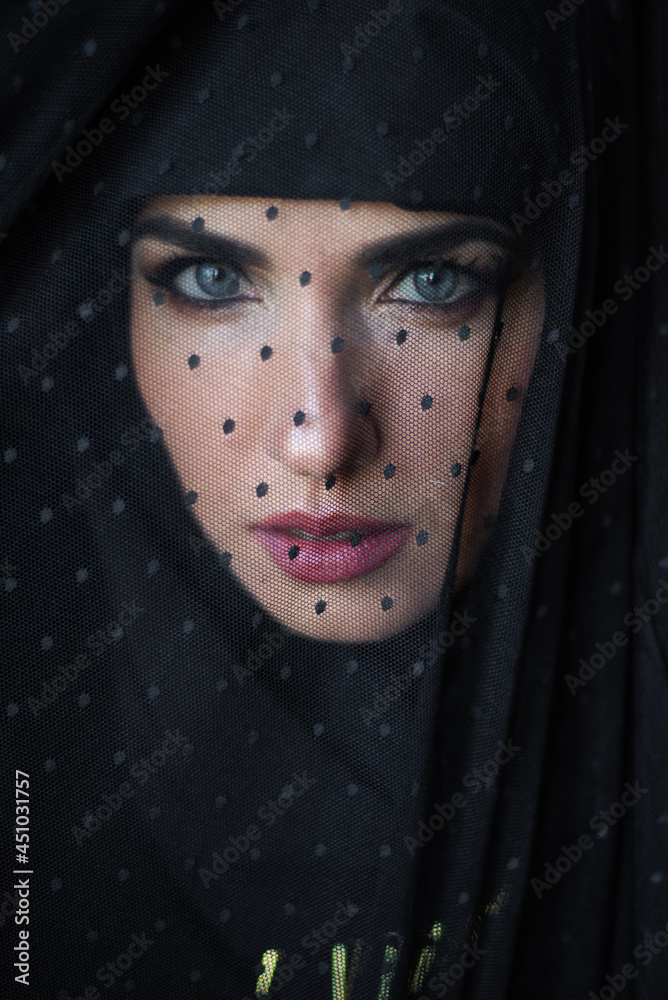Beautiful woman portrait under black veil