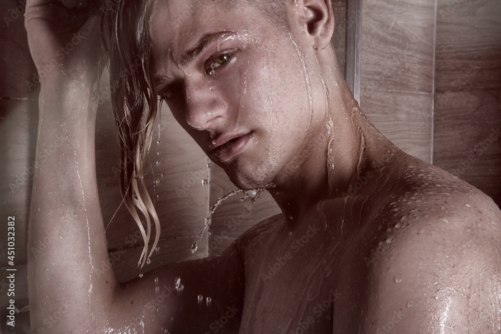 Young attractive guy washes in the shower. Young attractive guy washes in the shower.