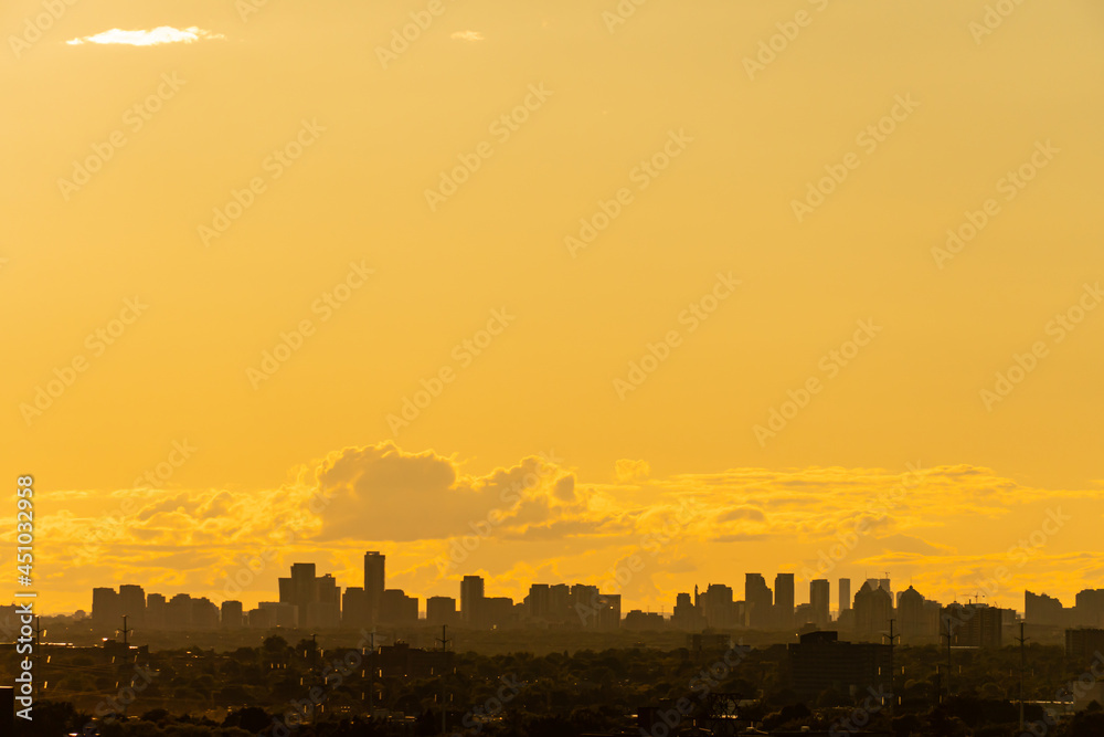 Toronto Canada scenic view of cityscape skyline at hot scorch summer evening sunset. Orange dusk sun lights and clouds. Climate change concept. Dramatic cloudscape.