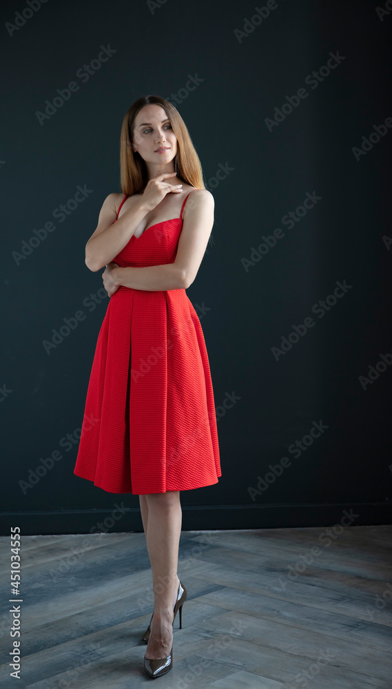 beautiful woman with a slender figure in full growth on a dark background. beautiful woman with a slender figure in full growth on a dark background.