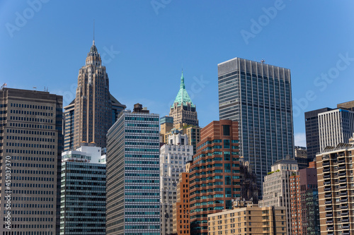 Lower Manhattan skyscraper stands under the blue sky on June 18, 2021 in New York City, USA. © STUDIO BONOBO