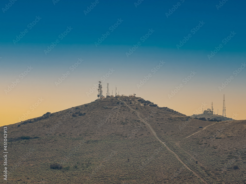 Communication towers on a mountain top in the Nevada desert near Reno.