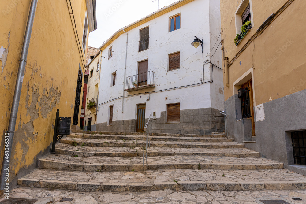 narrow street with stone stairs and old buildings.