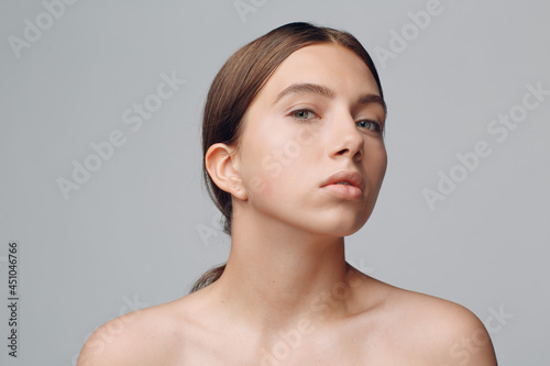 Portrait of young beautiful positive woman with nude make up