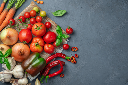 An assortment of fresh vegetables on a gray-blue background