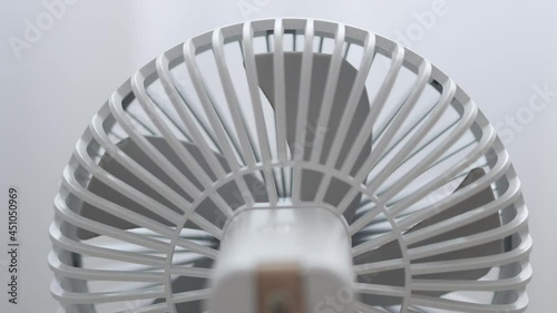 Wallpaper Mural Modern white cooling portable electric fan on light white background. The curtain develops in the wind by the window. Back view Torontodigital.ca