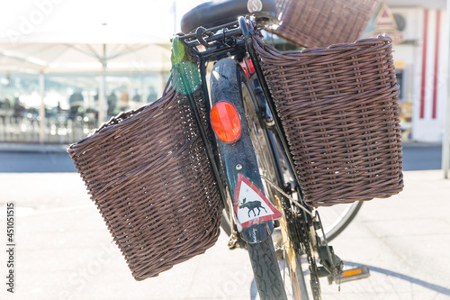 bicycle with rear wicker pannier baskets in the street