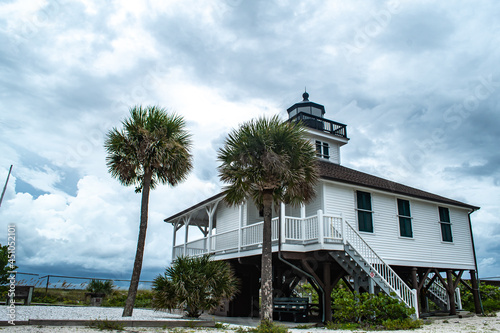 Port Boca Grande Lighthouse and Museum stand strong on Gasparilla Island as a tropical storm with black clouds loom of the coast in the Gulf of Mexico