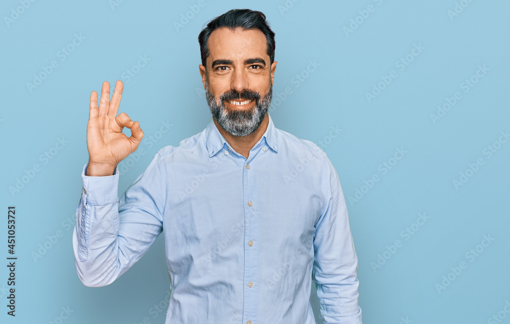 Middle aged man with beard wearing business shirt smiling positive doing ok sign with hand and fingers. successful expression. Middle aged man with beard wearing business shirt smiling positive doing ok sign with hand and fingers. successful expression.