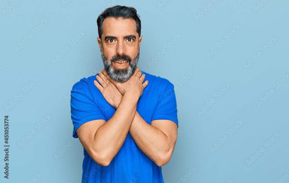 Middle aged man with beard wearing casual blue t shirt shouting and suffocate because painful strangle. health problem. asphyxiate and suicide concept. Middle aged man with beard wearing casual blue t shirt shouting and suffocate because painful strangle. health problem. asphyxiate and suicide concept.