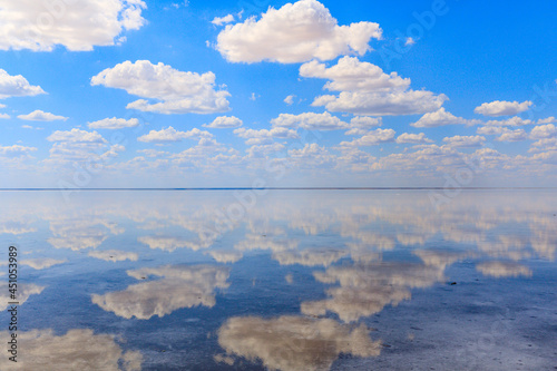 amazing panorama of Lake Elton on a summer day, beautiful sky with clouds and its reflection in the water.