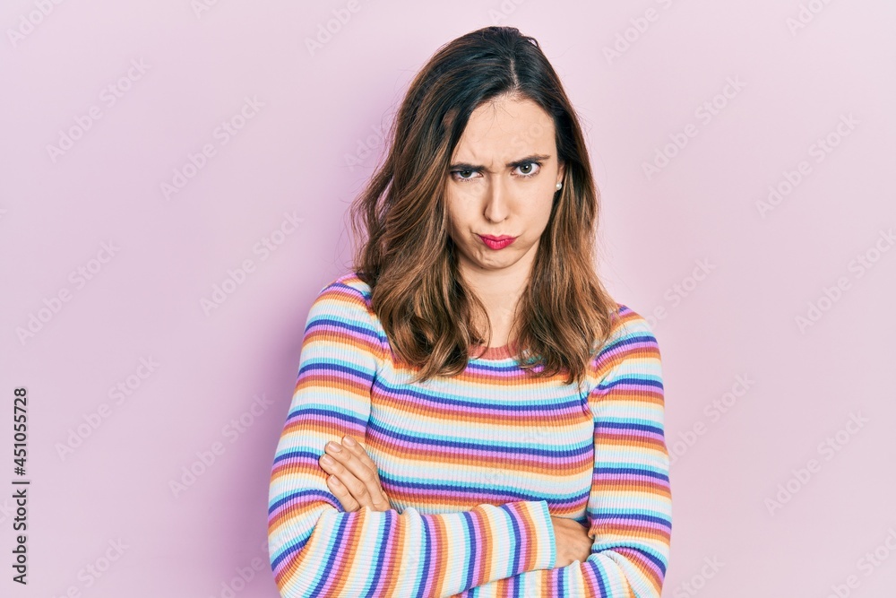 Young hispanic girl wearing casual clothes skeptic and nervous, disapproving expression on face with crossed arms. negative person. Young hispanic girl wearing casual clothes skeptic and nervous, disapproving expression on face with crossed arms. negative person.