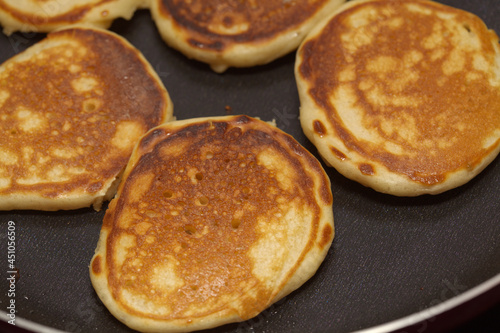 making thick pancakes on dark griddle surface