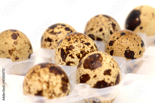 small speckled quail eggs isolated on white background