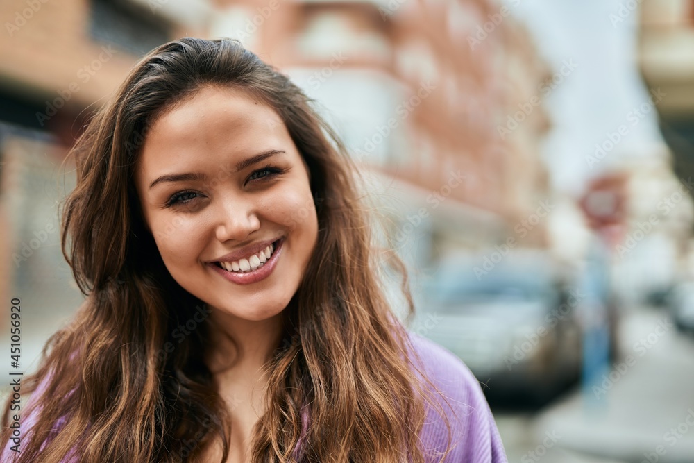 Young hispanic woman smiling happy standing at the city. Young hispanic woman smiling happy standing at the city.