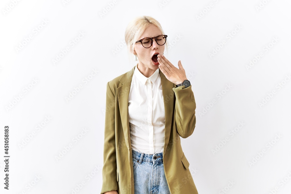 Beautiful caucasian business woman standing over isolated background bored yawning tired covering mouth with hand. restless and sleepiness.