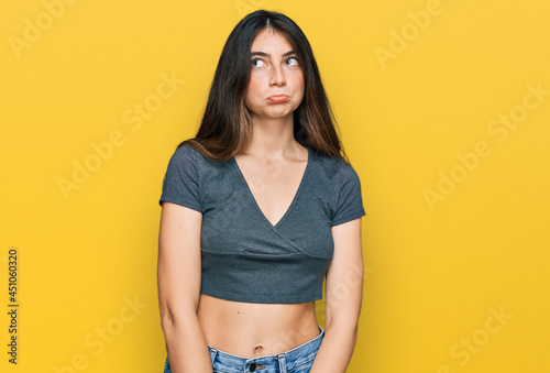 Young beautiful teen girl wearing casual crop top t shirt depressed and worry for distress, crying angry and afraid. sad expression.