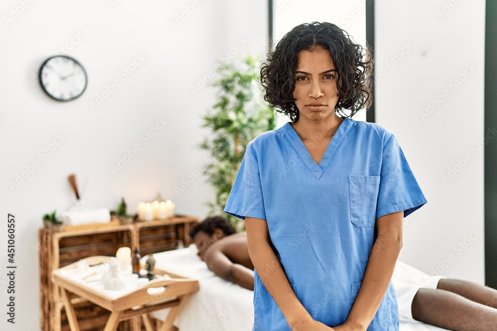 Young therapist woman at wellness spa center skeptic and nervous, frowning upset because of problem. negative person. Young therapist woman at wellness spa center skeptic and nervous, frowning upset because of problem. negative person.