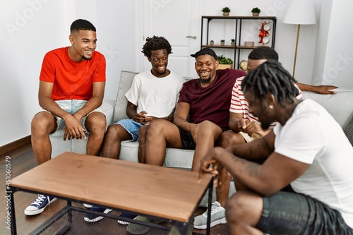Group of african american people smiling happy sitting on the sofa at home.