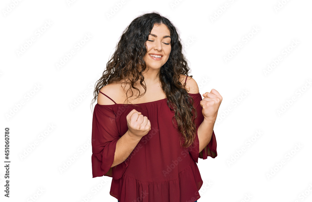 Young hispanic girl wearing casual clothes excited for success with arms raised and eyes closed celebrating victory smiling. winner concept.