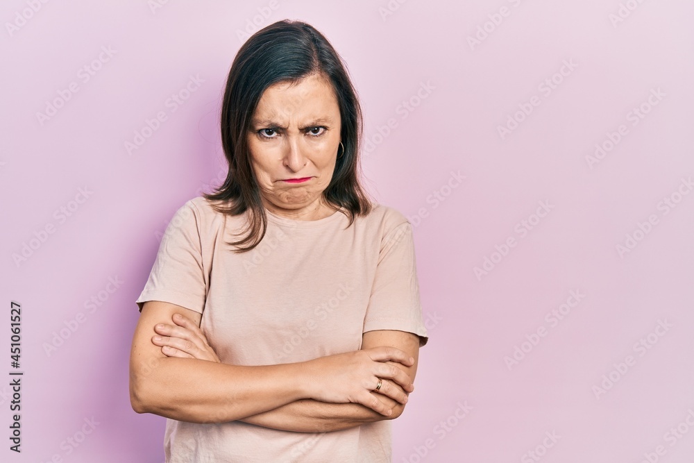 Obraz premium Middle age hispanic woman with arms crossed gesture skeptic and nervous, frowning upset because of problem. negative person.