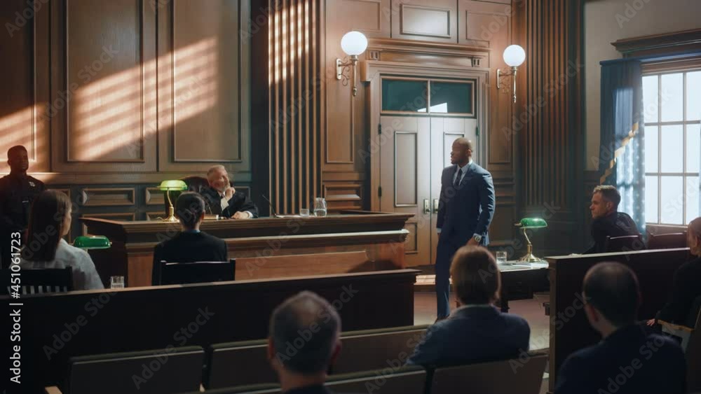 Court of Justice and Law Trial: Male Public Defender Presenting Case, Making Passionate Speech to Judge, Jury. African American Attorney Lawyer Protecting Client's Innocents with Supporting Argument.