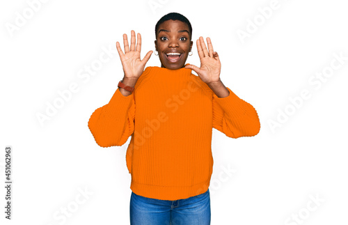 Young african american woman wearing casual clothes showing and pointing up with fingers number nine while smiling confident and happy.