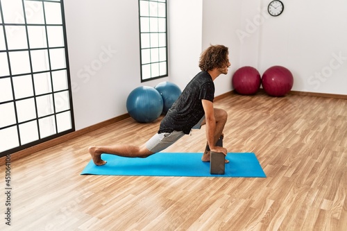 Young hispanic sporty man concentrate training at sport center.