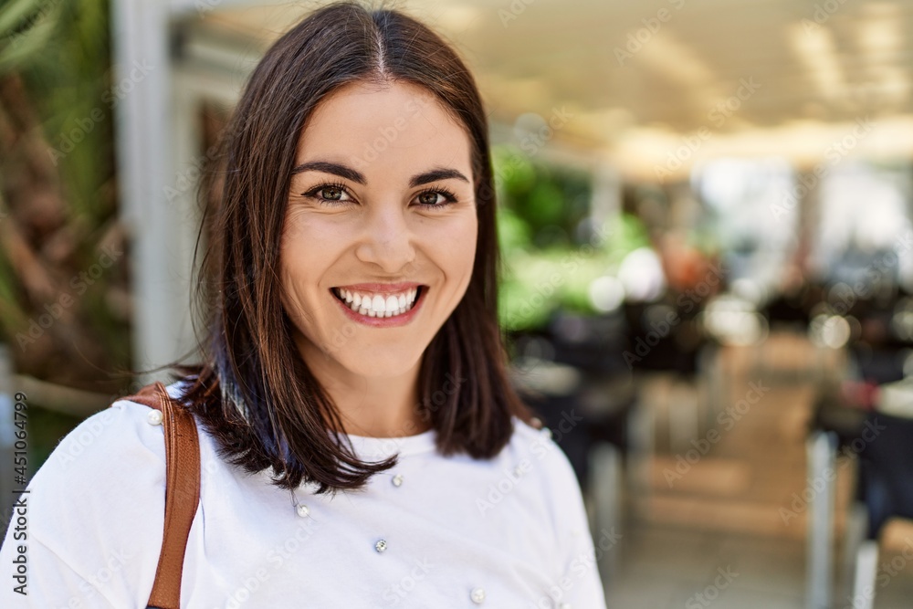Young hispanic girl smiling happy standing at the city. Young hispanic girl smiling happy standing at the city.