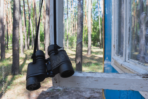 Binoculars in the forest on the window, travel