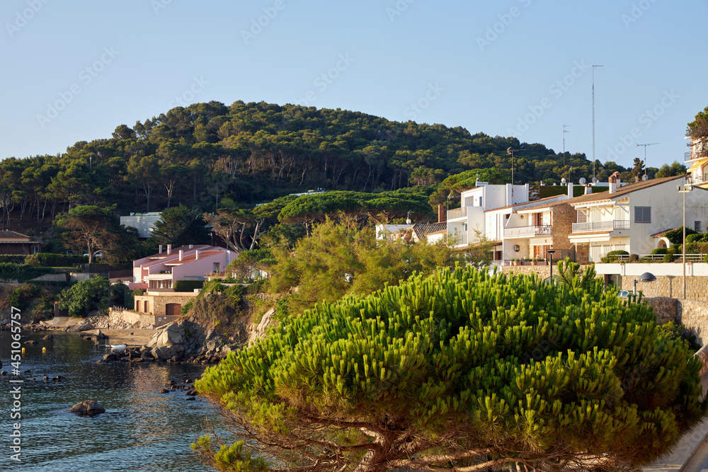 Morning landscape, sunrise over the river, sandy beach near the shore are boats.