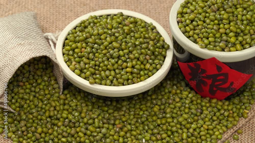 Mung beans on burlap against dark background Mung beans on burlap against dark background