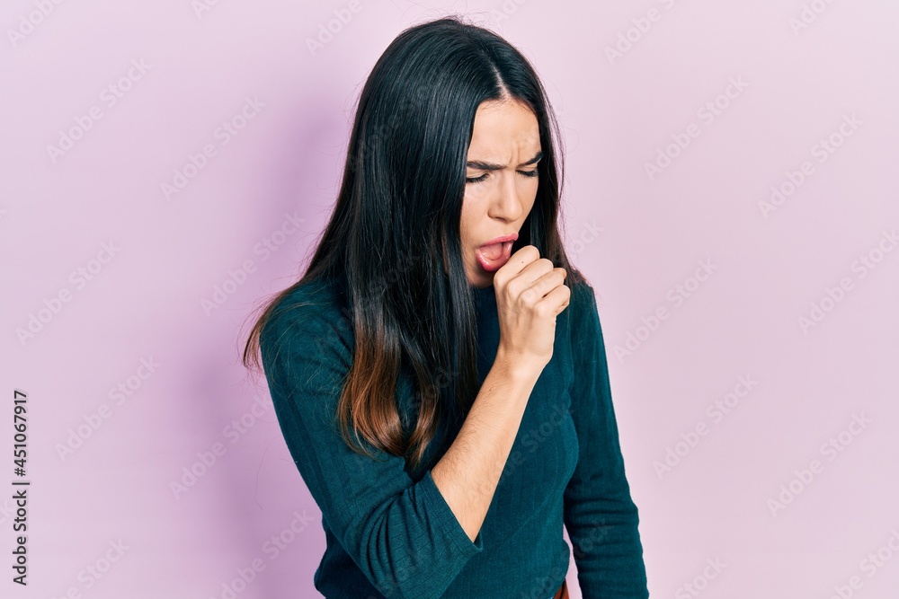 Young brunette woman wearing casual winter sweater feeling unwell and coughing as symptom for cold or bronchitis. health care concept. Young brunette woman wearing casual winter sweater feeling unwell and coughing as symptom for cold or bronchitis. health care concept.