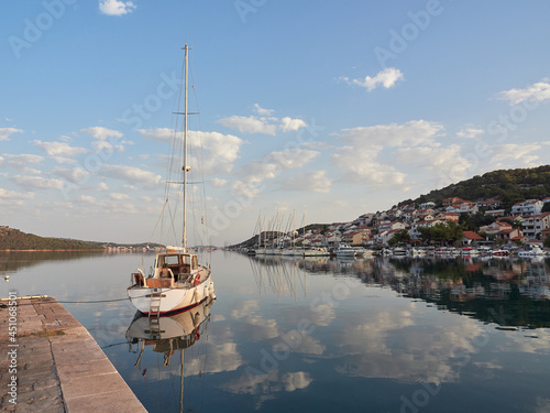 Tisno, Croatia - City landscape in the morning overlooking the marina with boats. Murter Island. photo