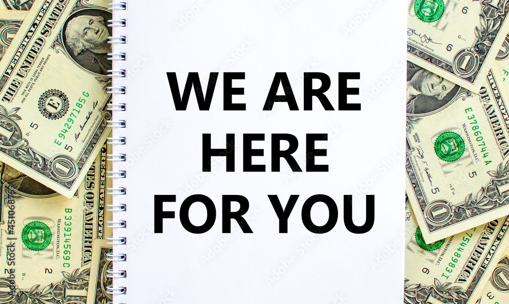 Support symbol. Words 'we are here for you' on white note. Beautiful background from dollar bills. Copy space. Business and support concept. Support symbol. Words 'we are here for you' on white note. Beautiful background from dollar bills. Copy space. Business and support concept.