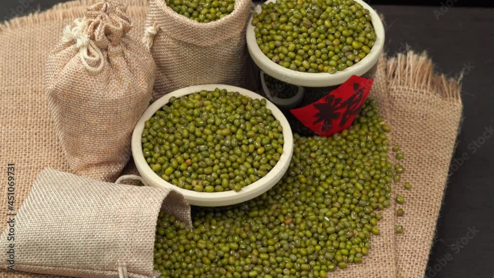 Mung beans on burlap against dark background Mung beans on burlap against dark background