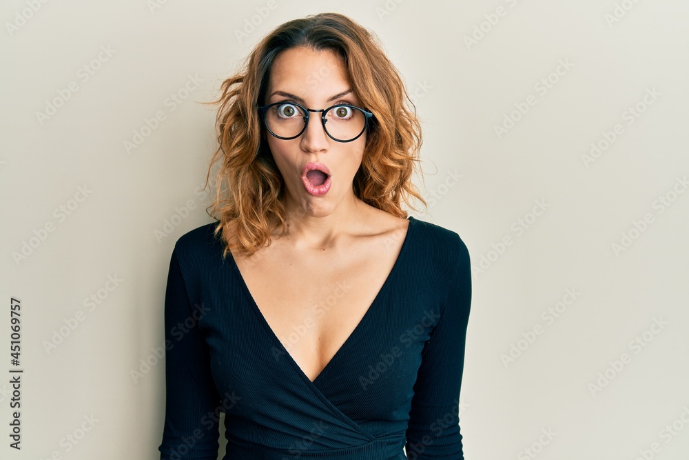 Young caucasian woman wearing business shirt and glasses afraid and shocked with surprise expression, fear and excited face. Young caucasian woman wearing business shirt and glasses afraid and shocked with surprise expression, fear and excited face.