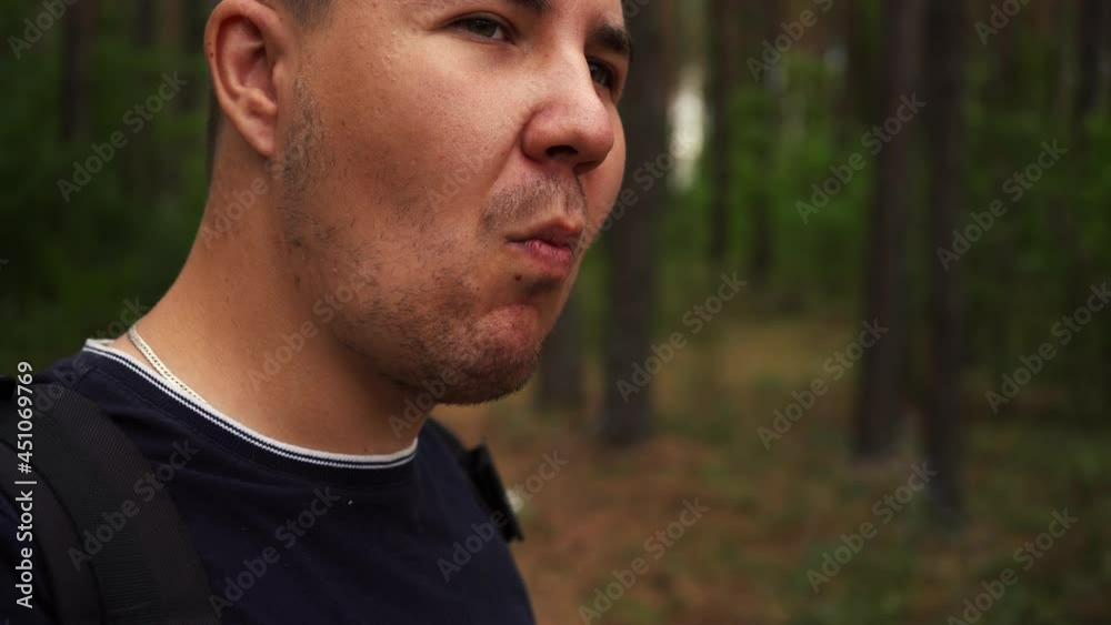 man lights a cigarette while in the woods man lights a cigarette while in the woods