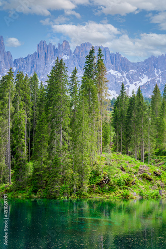 Paradise scenery at Karersee (Lago di Carezza, Carezza lake) in Dolomites of Italy at Mount Latemar, Bolzano province, South tyrol. Blue and crystal water. Travel destination of Europe.