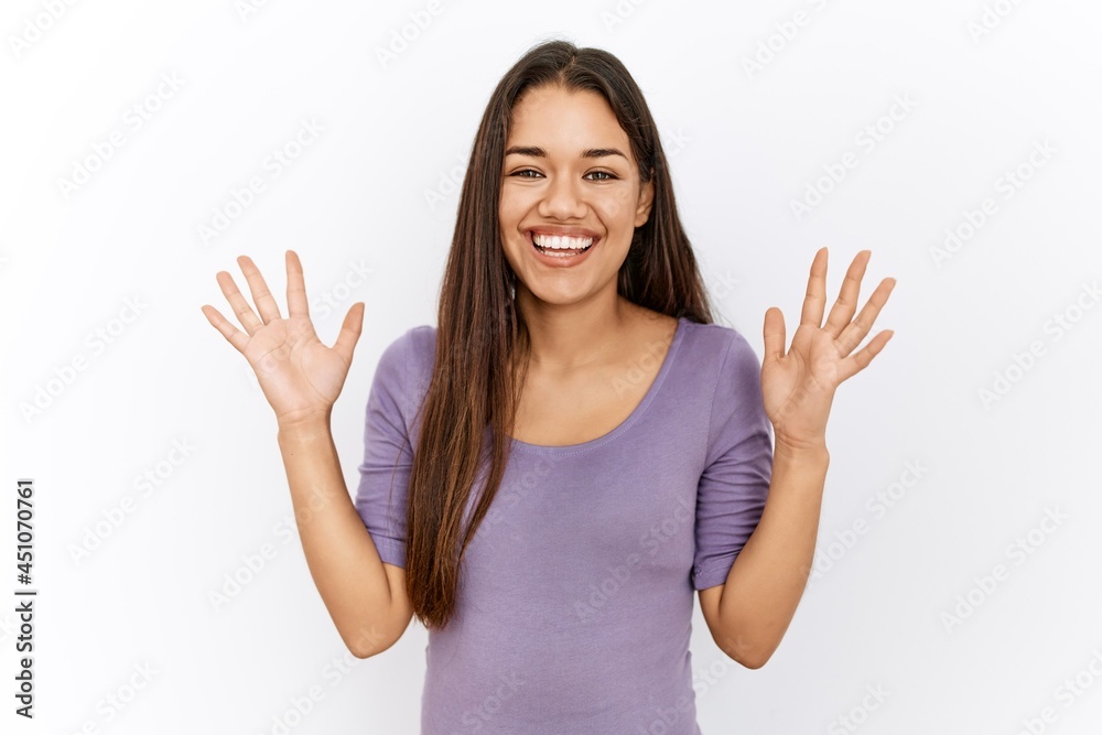 Young brunette woman standing by isolated background celebrating crazy and amazed for success with arms raised and open eyes screaming excited. winner concept Young brunette woman standing by isolated background celebrating crazy and amazed for success with arms raised and open eyes screaming excited. winner concept