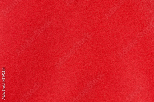 Crimson red textured smooth leather surface background, small grain