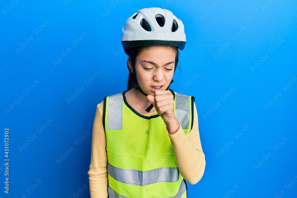 Beautiful brunette little girl wearing bike helmet and reflective vest feeling unwell and coughing as symptom for cold or bronchitis. health care concept. Beautiful brunette little girl wearing bike helmet and reflective vest feeling unwell and coughing as symptom for cold or bronchitis. health care concept.