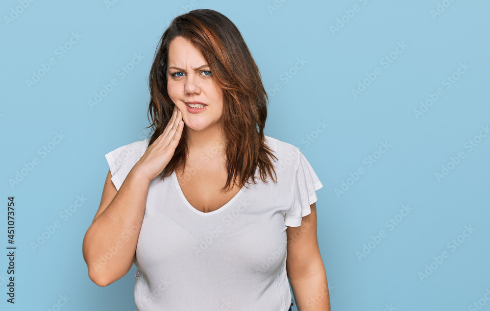 Young plus size woman wearing casual white t shirt touching mouth with hand with painful expression because of toothache or dental illness on teeth. dentist Young plus size woman wearing casual white t shirt touching mouth with hand with painful expression because of toothache or dental illness on teeth. dentist