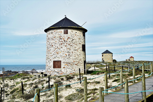 Photography Closeup shot of a windmill near a sea in Northern Littoral Natural Park, Portuga