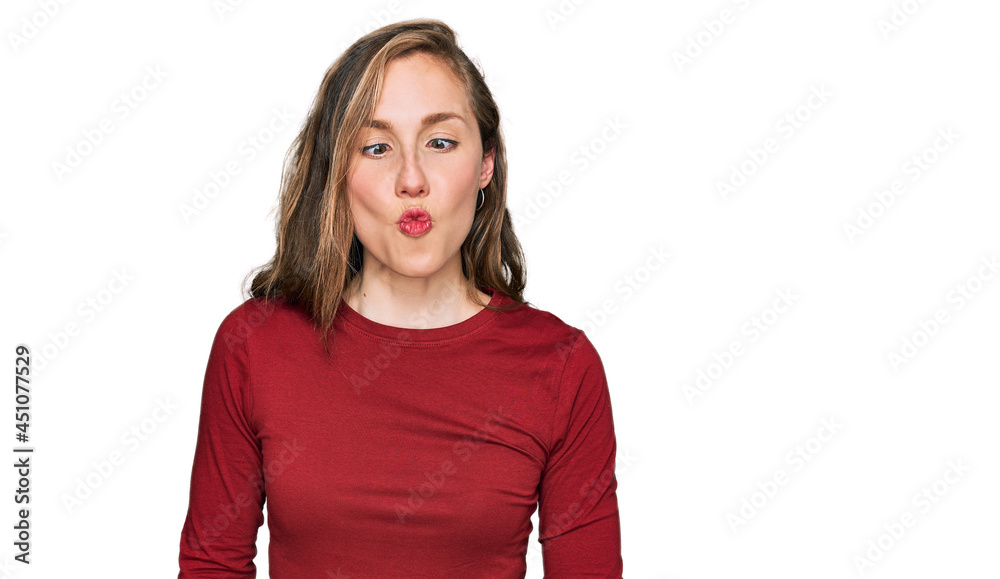 Young blonde woman wearing casual clothes making fish face with lips, crazy and comical gesture. funny expression. Young blonde woman wearing casual clothes making fish face with lips, crazy and comical gesture. funny expression.
