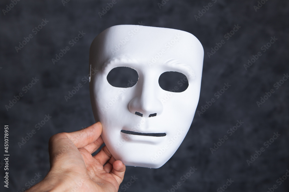 holding a white anonymous mask holding a white anonymous mask