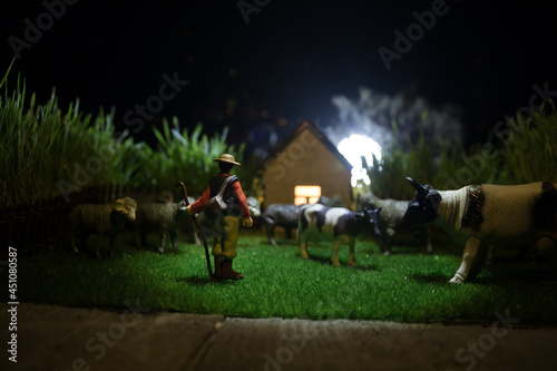 Sheep in the farm. Farm (village) life concept. Decorative toy figures at night. Selective focus