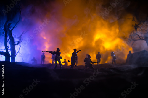 War Concept. Military silhouettes fighting scene on war fog sky background, World War Soldiers Silhouette Below Cloudy Skyline At night. Battle in ruined city. Selective focus